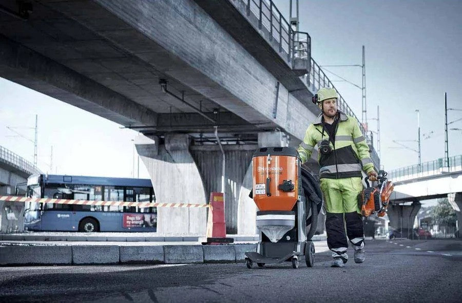 man walking with dust extractor