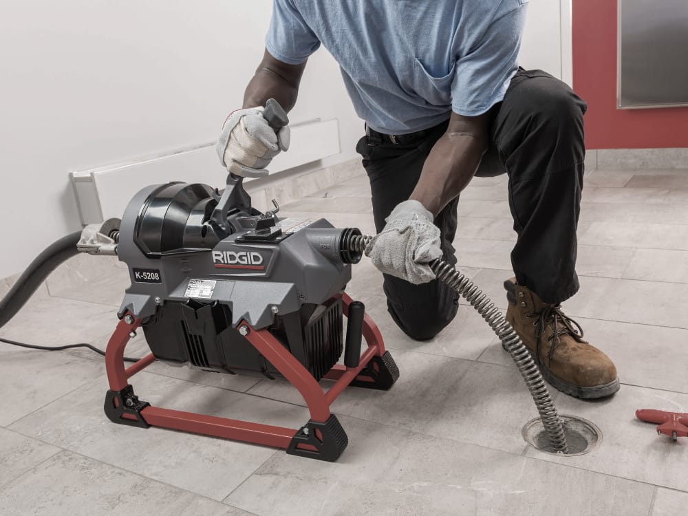 Man using a Ridgid Drain Cleaner