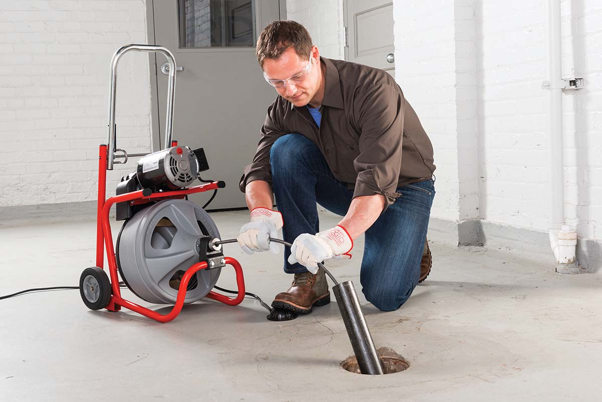 Man utilizing a Ridgid drum machine